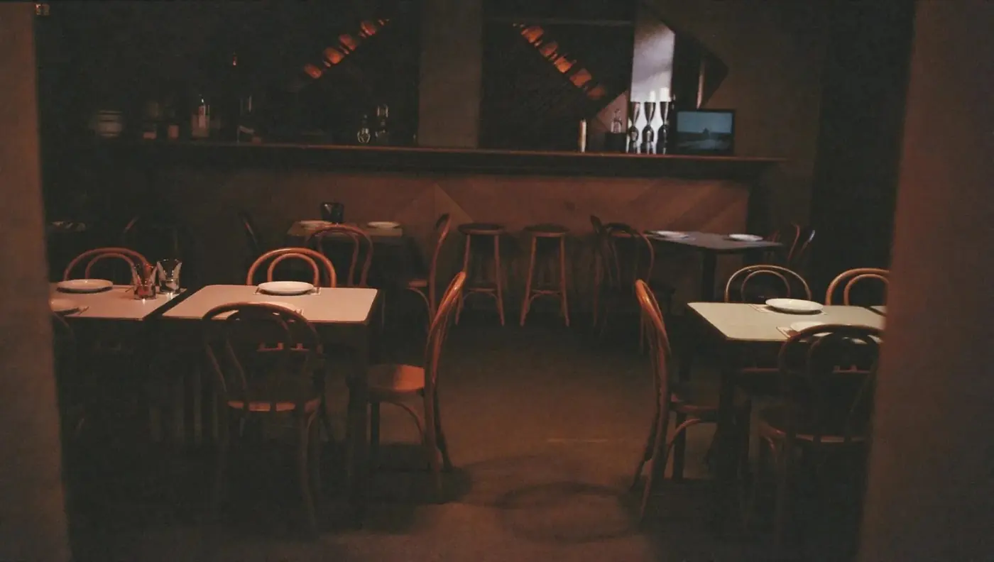 A wide, quiet view of the dining room and bar
